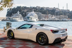 Monte Carlo, Monaco 7 December 2018, Ferrari 458 Italia Spider 2019 white, stands on parking slot with city background to yachts